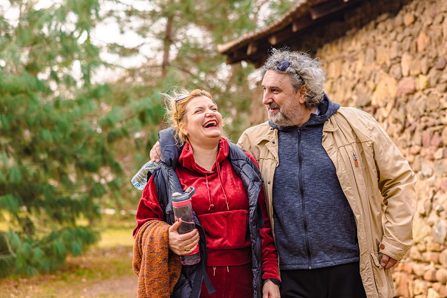 Two people laughing while walking