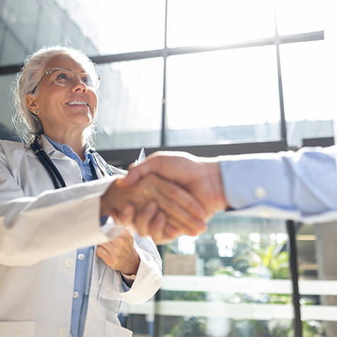 Doctor shaking hands with a person